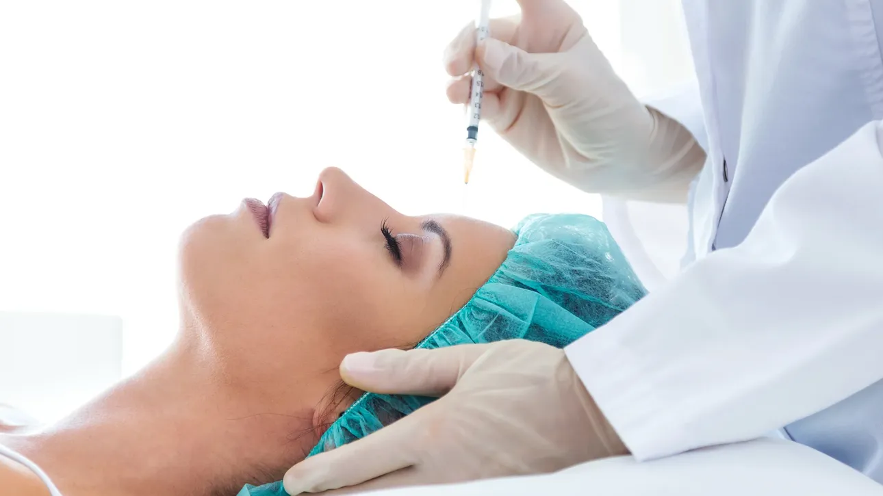 Woman receiving a Botox injection to reduce forehead wrinkles at Akasha Wellness & Spa.