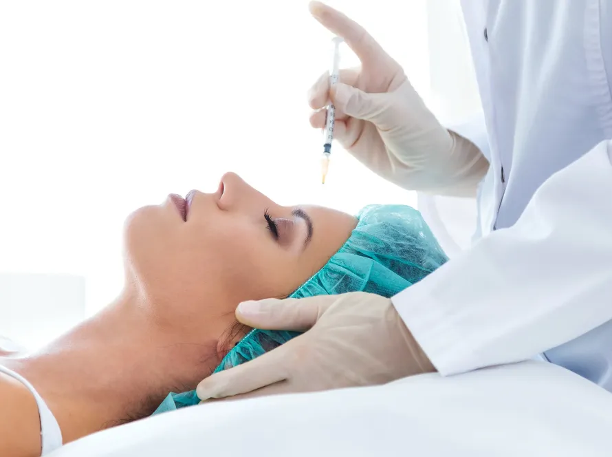 Woman receiving a Botox injection to reduce forehead wrinkles at Akasha Wellness & Spa.