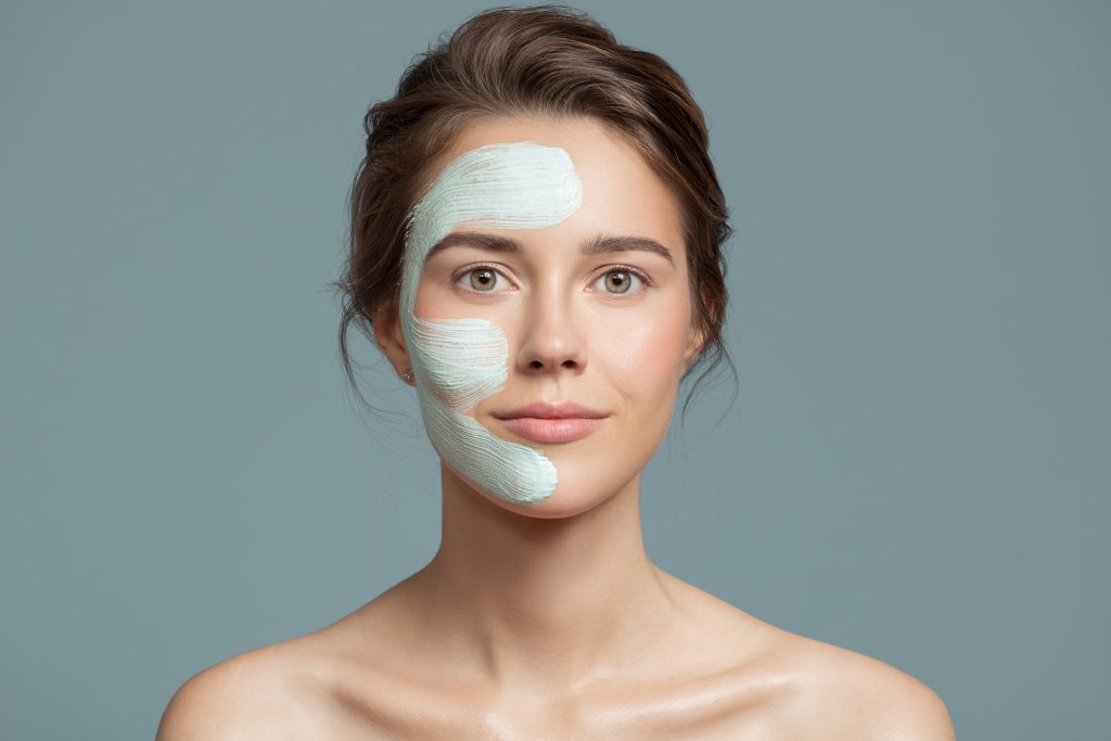 Woman applying a brightening face mask as part of her 10 must-have skincare products