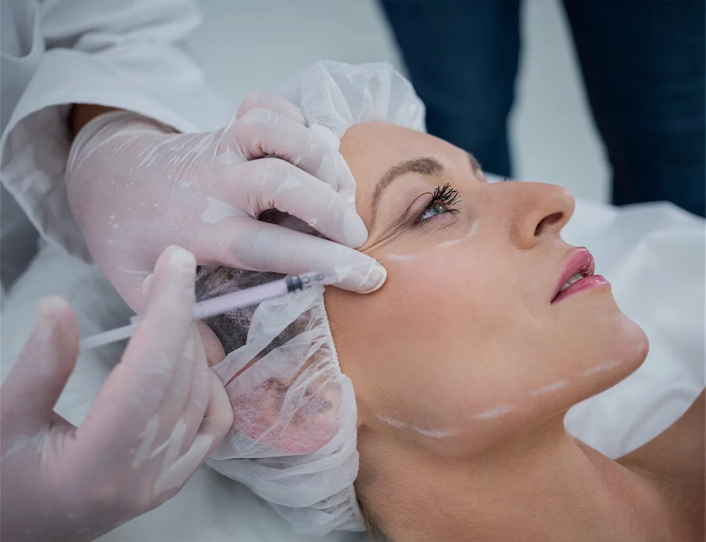 Woman receiving a Botox injection to treat frown lines between the eyebrows at Akasha